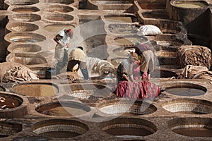 FEZ, MOROCCO Ã¢â¬â FEBRUARY 20, 2017 : Men working at the famous Chouara Tannery in the medina of Fez, Morocco